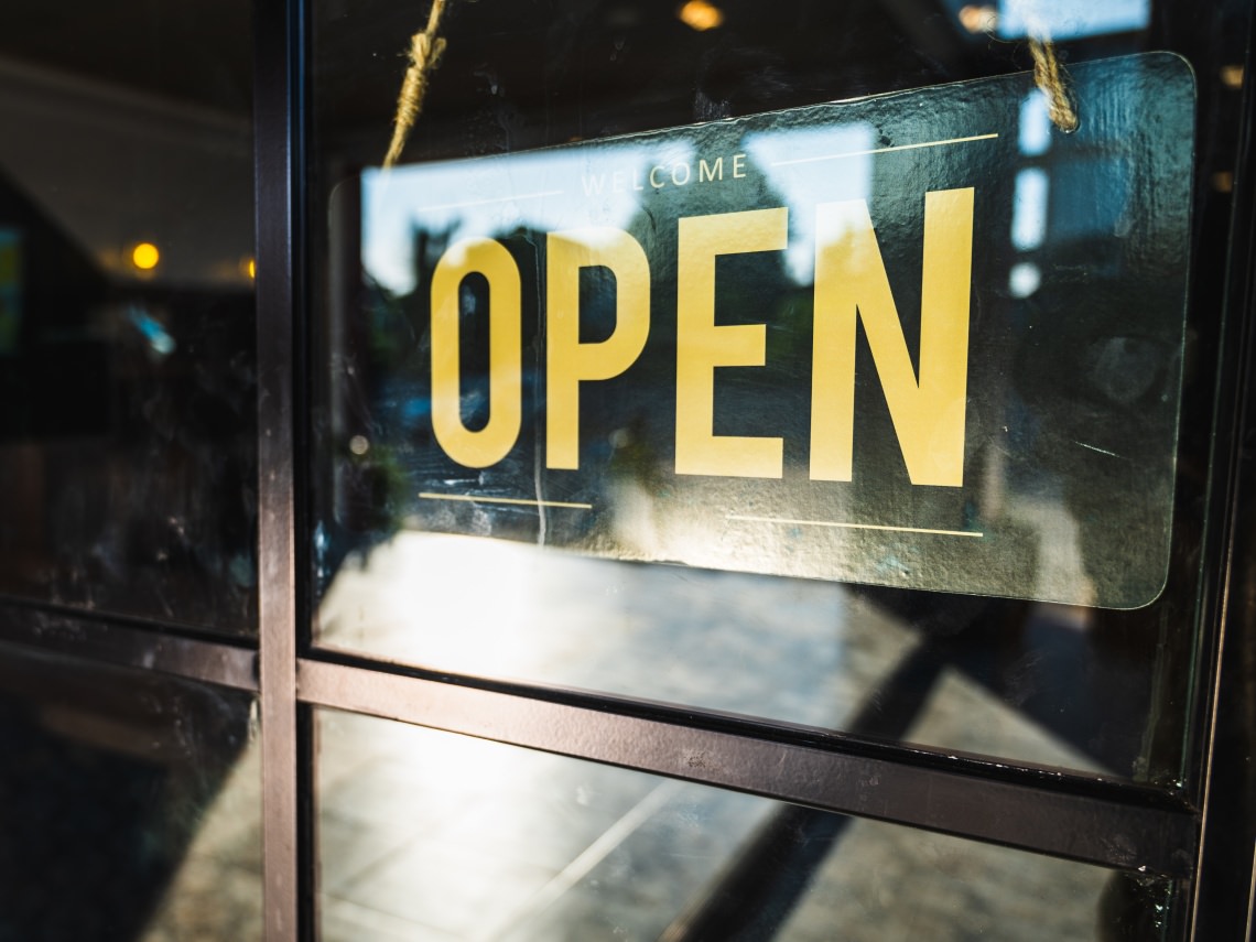 open sign hanging from a business' window
